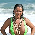 Pic of Alicia DeMarco shows huge boobs in sling bikini playing on beach @ Busty Cafe