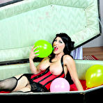 Pic of Busty Vampire Kymberly Jane popping balloons inside her coffin