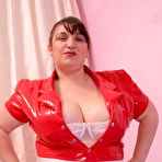 Pic of Plump nurse in red latex plays and oils her monster breasts
