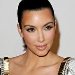 Pic of Kim Kardashian posing for paparazzi in short white dress