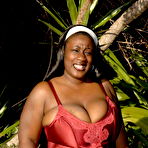 Pic of Total plumper ebony exposes her big heavy hooters outdoors