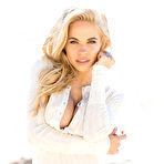 Pic of Dani Mathers rolling around in the sand on a beautiful beach
