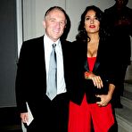 Pic of Salma Hayek slight cleavage in red dress at Yves Saint Laurent fashion show
