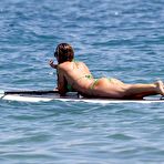 Pic of Abigail Clancy paddleboarding in green bikini