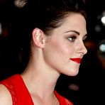 Pic of Kristen Stewart posing in red dress at Cosmopolis Premiere