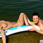 Pic of Adorable nudists with perfect asses relaxing on the air bed. Enjoy the pics