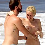 Pic of Miley Cyrus caught topless on a beach