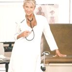 Pic of Lewd nurse in white uniform Farrah turning into a wild stripteaser hot posing on camera.