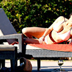 Pic of Busty Casey Batchelor cameltoe in bikini poolside