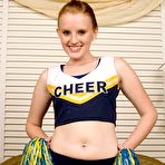 Pic of Petite smiling cheerleader Katey Grind gets totally nude and displays her shaved pink pussy