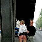 Pic of Blonde Angie in nylons, boots and mini skirt shows her bald pussy in the street