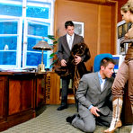 Pic of Beautifully dressed Gina Killmer humiliates two naked guys in her office