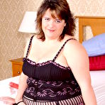 Pic of Elegant brunette fattie Lizzy in beautiful black lingerie sucks red dildo in the bedroom