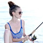 Pic of Brunette teen Emily Bloom goes fishing in her short dress and exposes her hairy pussy outdoors.