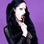 Pic of Raven haired pigtailed goth chick Fetus de Milo with lollipop poses topless in pantyhose