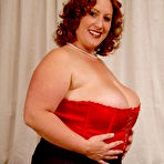 Pic of Redhead plumper Nikki Cars in red corset and white stockings gets her fat pussy banged
