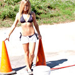 Pic of Bikini babe Meet Madden gets wet and messy outdoors while playing with a water hose.
