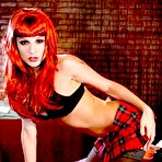 Pic of Baring her plaid skirt and black lingerie sassy redhead Kirsten Price poses in stockings