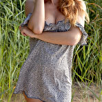 Pic of Busty redhead in a dress flashes her juicy pussy on a sandy beach - aMetart.com