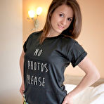Pic of Colorfully dressed and lovely-looking brunette teen undressing on a bed - aMetart.com