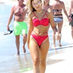 Pic of Tallia Storm in red bikini on a beach