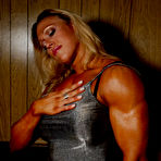 Pic of Blonde bodybuilder Colette Nelson in dress and nylons shows of her heavy muscles