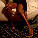 Pic of Ebony bodybuilder Tatianna Butler in black dress shows off her legs and cleavage in the bedroom