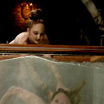 Pic of Audrey Leigh gets strapon fucked from behind right in a big water tank made of glass