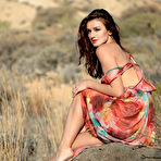 Pic of Elina Love undresses as the wind blows through her dress and long hair