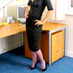 Pic of Sexy blonde secretary in black suit and purple nylons gets sexy in the office