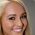 Pic of Pretty blonde Ashley Stone is smiling into camera and showing mouth filled with jizz of two rods