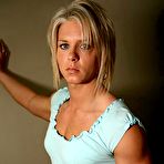 Pic of Slim blonde Kristen Curlee in white bra and blue mini skirt shows her hard muscles