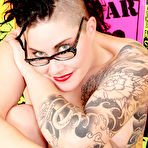 Pic of Inked up punk girl in glasses Michelle Aston fingers her shaved pussy and tight anal hole