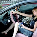 Pic of Skinny blonde Kelly FootFactory with slim legs kicks off her red shoes in a car