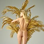 Pic of Candice B posing nude by a big golden plant