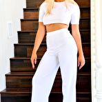 Pic of Blake Blossom removing her white shirt and pants on the stairs