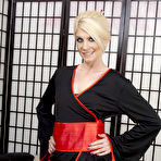Pic of British blonde milf Ashleigh McKenzie in black kimono, red corset and fishnets