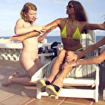 Pic of Lesbian domina Kym Wilde in bikini punishes naked Madison Young in the outdoors