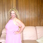 Pic of Curly big breasted chubby woman Serena Sutherland strips out of her pink dress