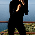 Pic of Teddy posing outdoor in black bodysuit, high heels and sunglasses