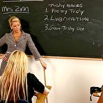 Pic of Donna Doll and another busty schoolgirl have fun with big strap-on dildo in front of their teacher