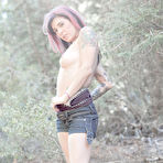 Pic of Naughty Joanna Angel with tattooed back double fingers her sexy asshole outdoors