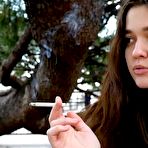 Pic of Russian Smokers | Young brunette is taking an unhurried stroll with allwhite 120mm cigarette