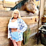 Pic of Blonde amateur Maddie Cross reveals her large boobs while going au naturel in a horse stall | NakedWomenPhotos.net