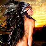 Pic of Tatted transgirl Danni Daniels models an indigenous headdress while naked in heels | TRANS.pics