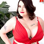 Pic of Tattooed BBW Nagini peels off a crimson dress while making her nude debut on a couch - Nude Women Pics