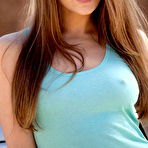 Pic of Dani Daniels showing off her awesome curves by her car