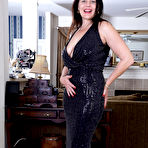 Pic of Older brunette Betsy Long gets completely naked on a rug during solo action