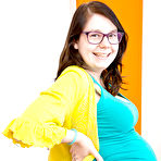 Pic of Glasses wearing amateur pregnant solo girl revealing baby bump and breasts