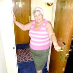 Pic of Obese grandmother licks her own nipples as she strips naked in living room